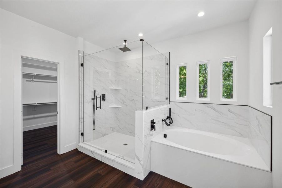 Bathroom with shower with separate bathtub and hardwood / wood-style floors