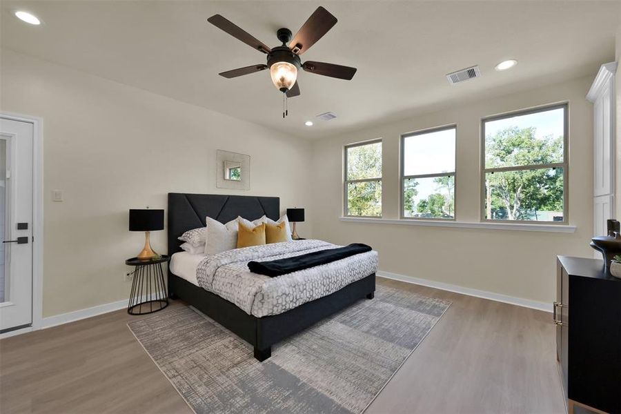 The primary bedroom gives a calming, relaxing vibe with large windows overlooking the front of the home.