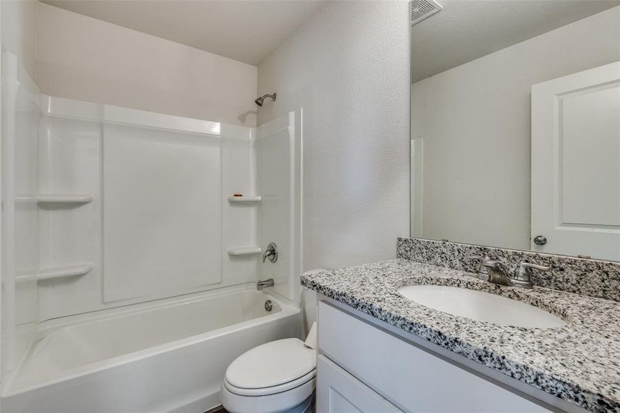 Full bathroom with shower / bathing tub combination, vanity, and toilet