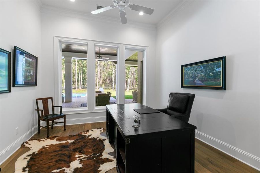 The office is complete with engineered floors, crown molding, and beautiful wood casing around the windows.