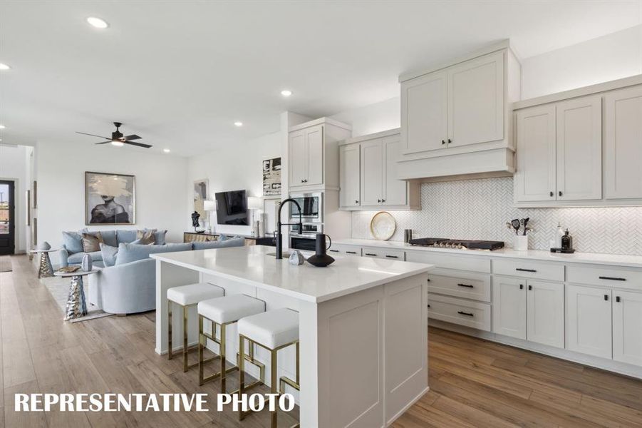 Featuring the perfect open concept design, entertaining is a breeze in our Madeleine floor plan.  REPRESENTATIVE PHOTO