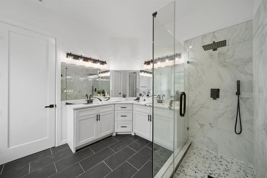 Bathroom with double vanity, walk in shower, and tile patterned floors