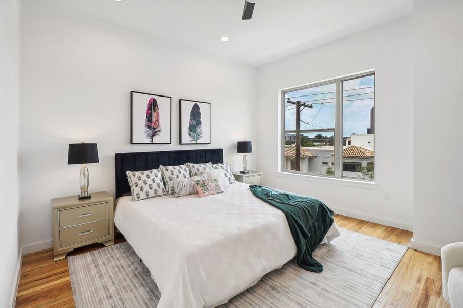 Bedroom with ceiling fan and light hardwood / wood-style flooring