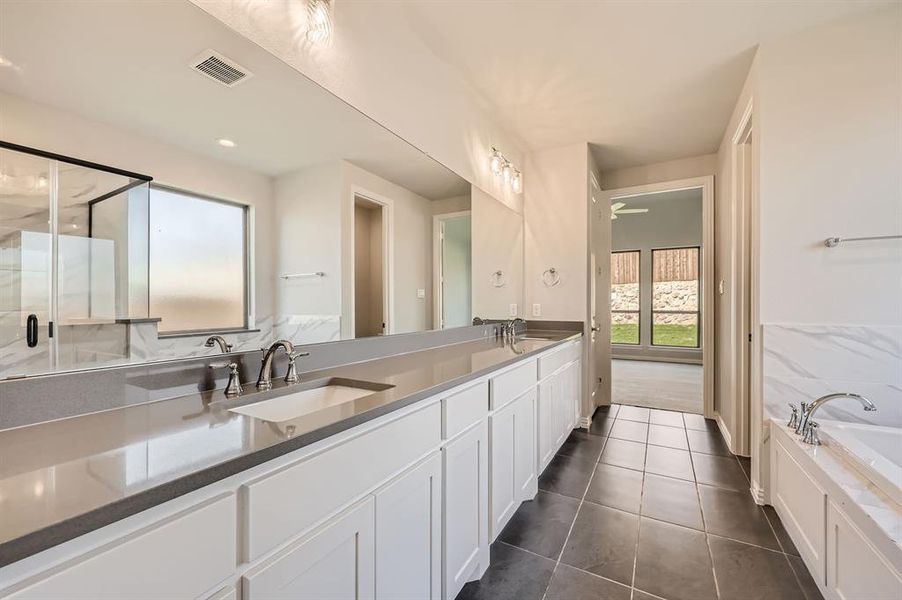 Bathroom featuring vanity, separate shower and tub, and tile patterned flooring