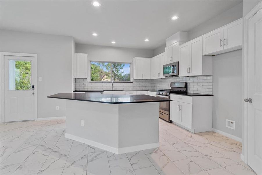 Island kitchen with Stainless Steel Appliances.