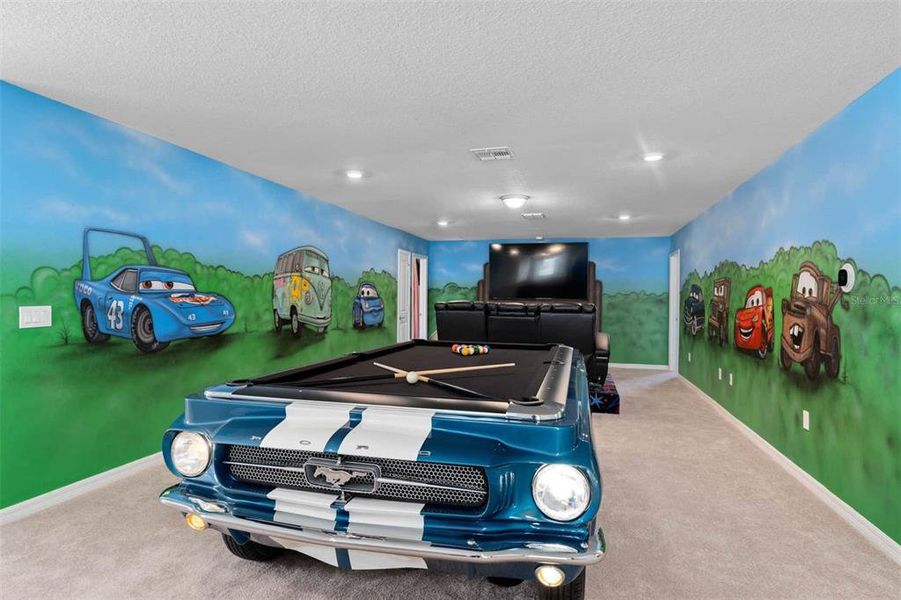 Truly a "Great" room. Equipped with a pool table and Movie Room with stadium seating! Vibrant airbrushing of all your favorite Cars characters.