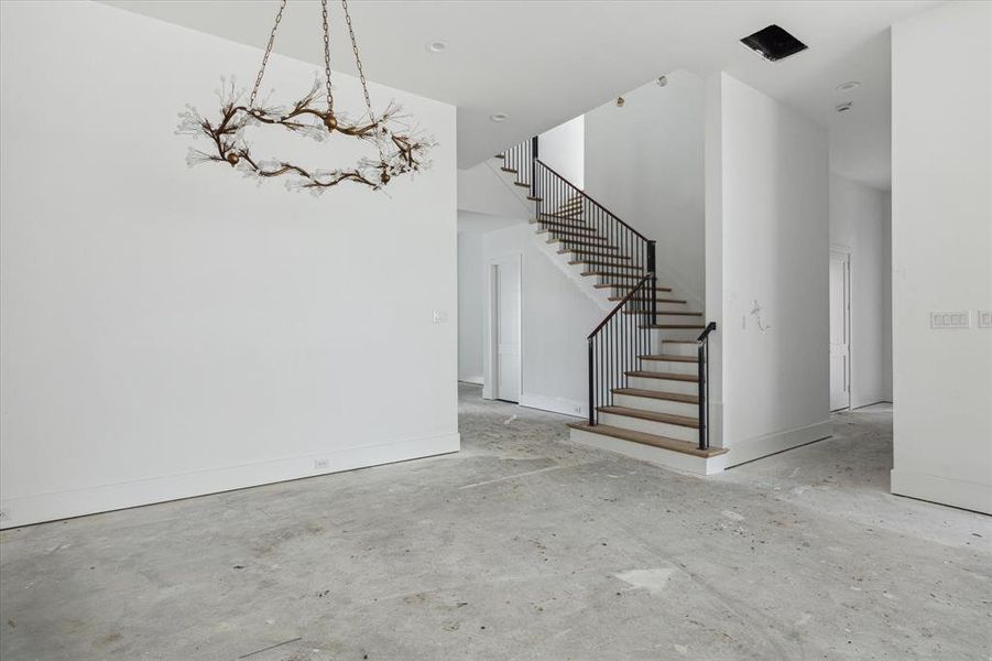 A view from the dining room back toward the entry to the left.  The mudroom and first floor powder room are nicely tucked away down the hall to the right of the picture.  A very thoughtful floorplan.  Photo as of 9/3/2024