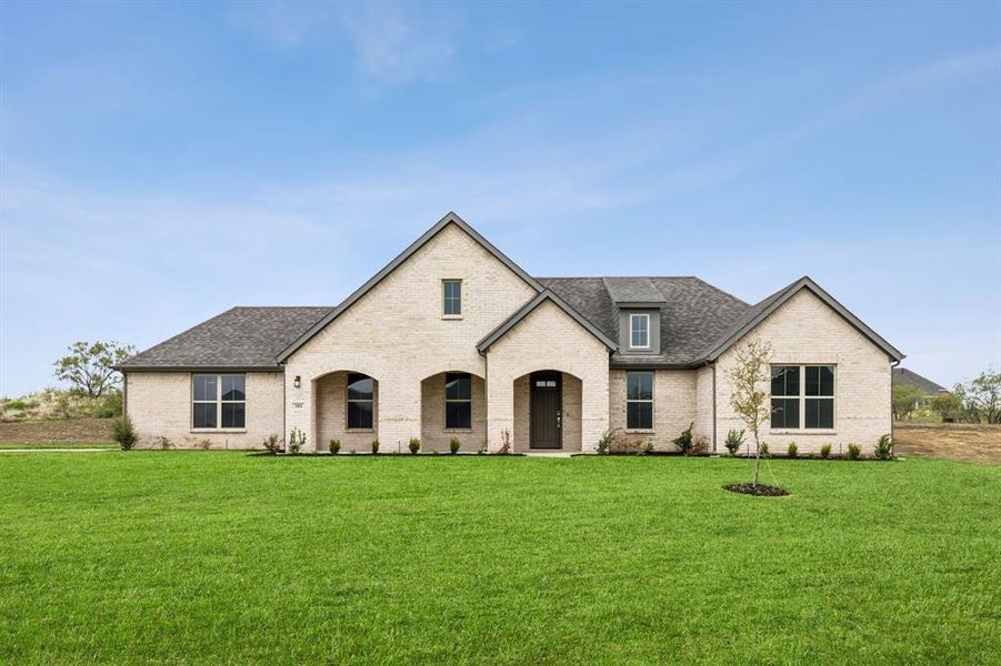 French provincial home with a front lawn