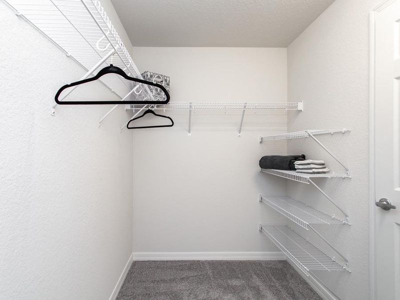 Walk-in wardrobe in the owner`s suite - Raychel home plan by Highland Homes