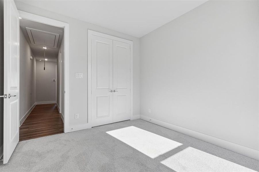 Unfurnished bedroom featuring carpet and a closet