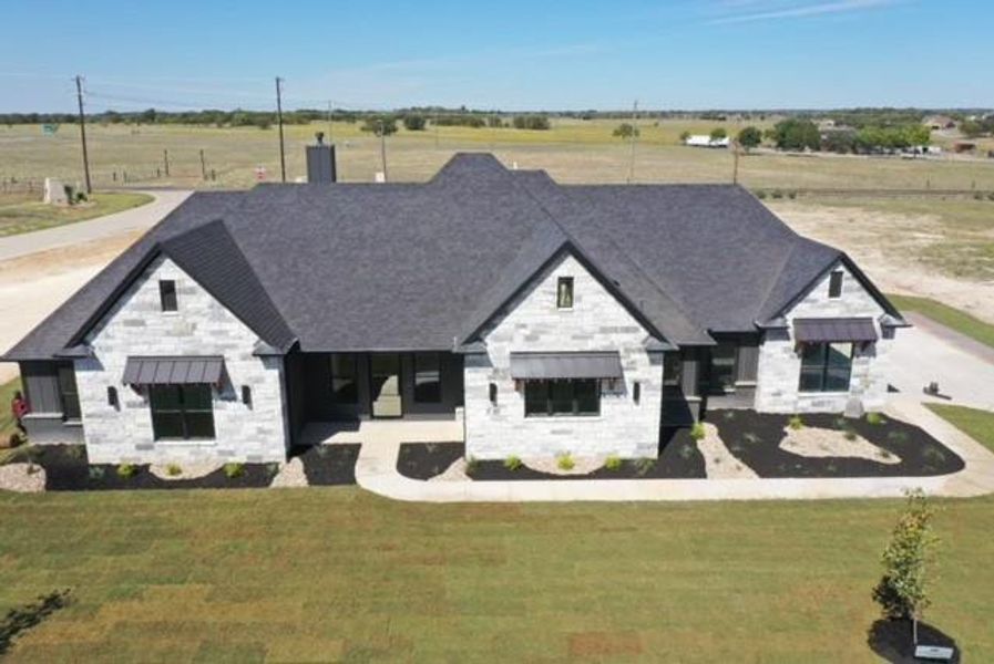 View of front facade with a rural view and a front lawn