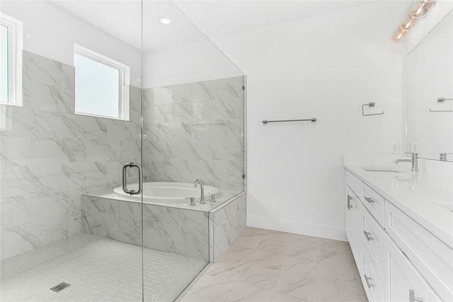 Bathroom featuring double vanity, plus walk in shower, and tile patterned flooring