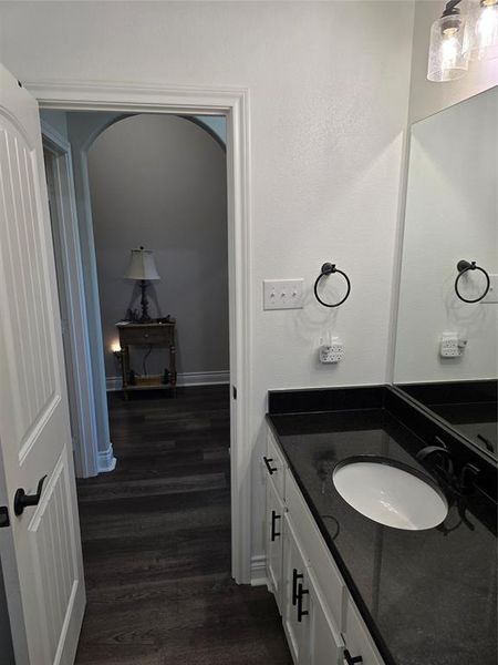 Bathroom with hardwood / wood-style floors and vanity