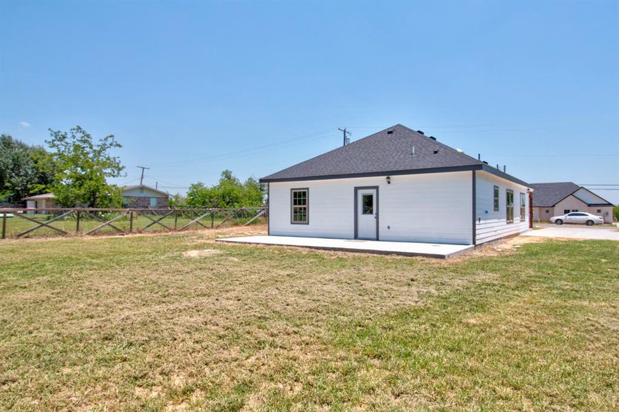 Back of property with a patio area and a lawn