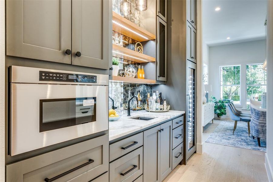 wet bar with built-in wine fridge. Positioned off the pantry, in between kitchen and dining room