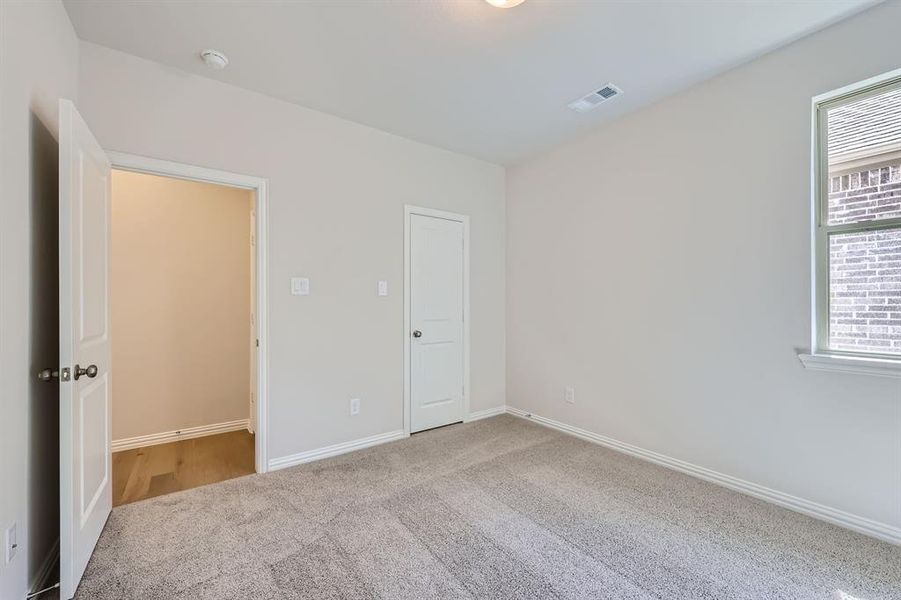 Bedroom featuring light carpet and a healthy amount of sunlight