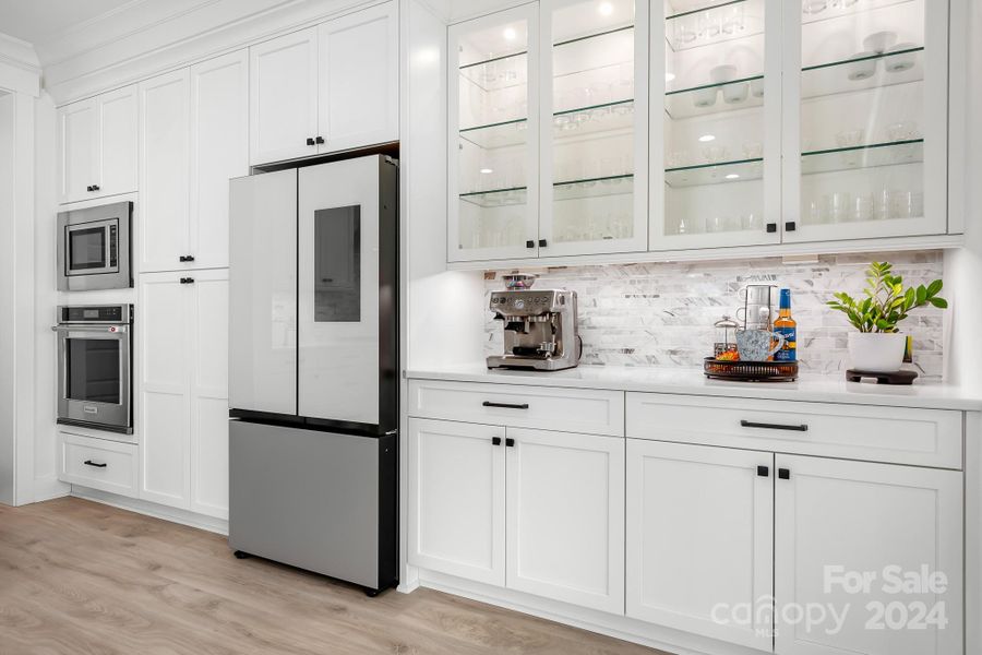 Wall ovens and tons of storage are features next to the butlers pantry.  Showcase upper cabinets that are lighted are great for displaying your dinnerware, glassware or collectibles.