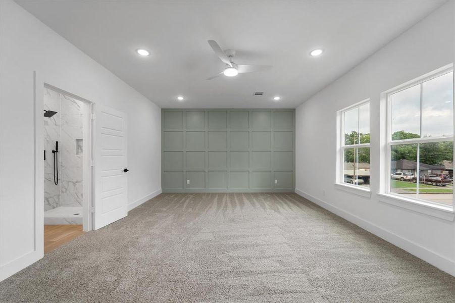 Your HUGE primary bedroom with recessed lights and a lovely accent wall. Plenty of room for your king-sized furniture, a desk, vanity, sitting area or an even a crib.