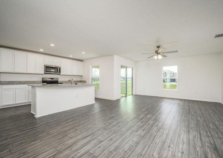 The kitchen has a large island that overlooks the entertainment space