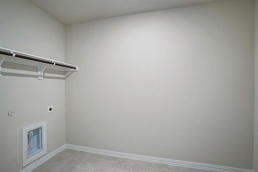 Washroom with light tile patterned floors and electric dryer hookup