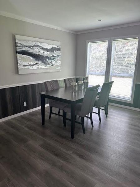 Dining area with crown molding and dark hardwood / wood-style floors