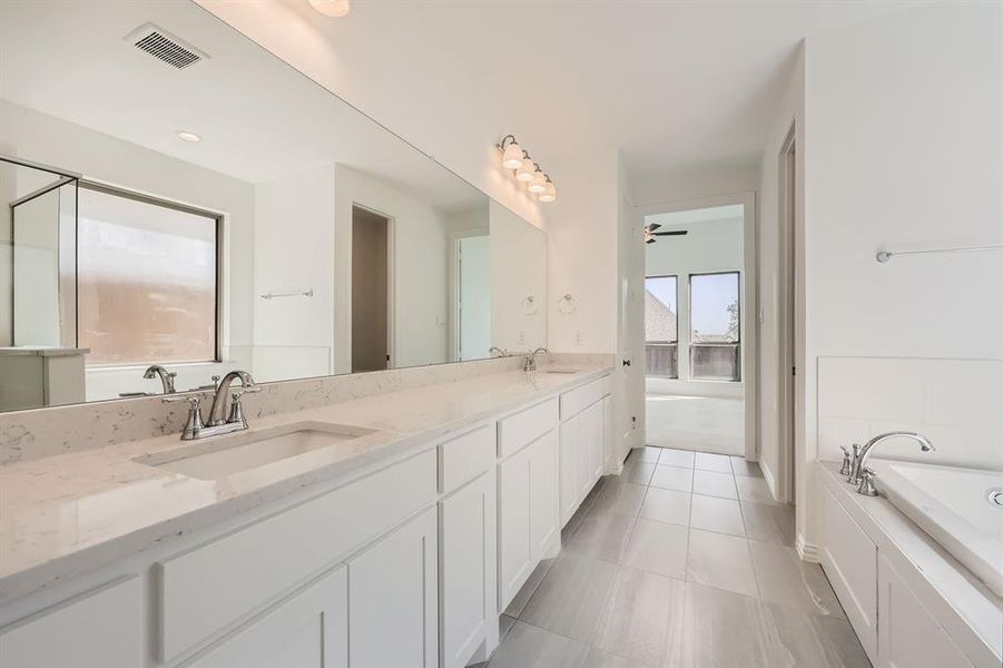 Bathroom with vanity, tile patterned floors, a washtub, and ceiling fan