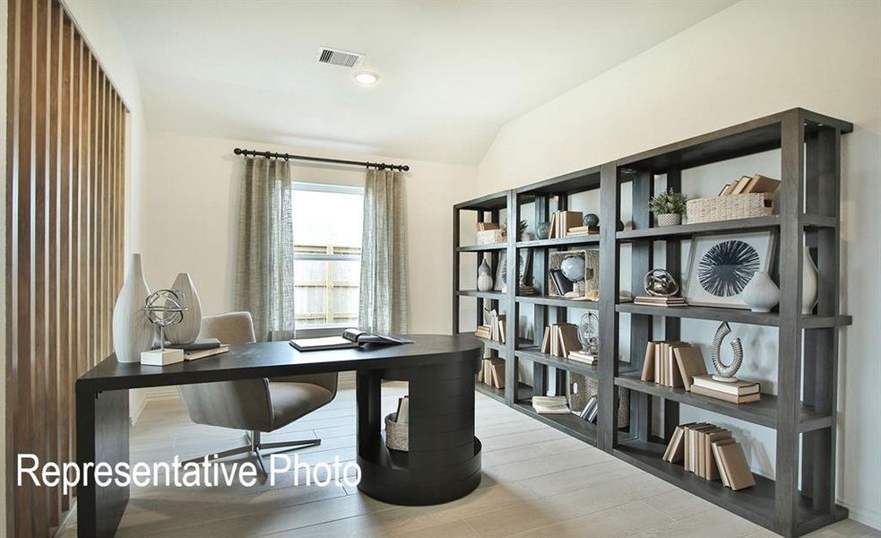 Office area with lofted ceiling and light hardwood / wood-style flooring