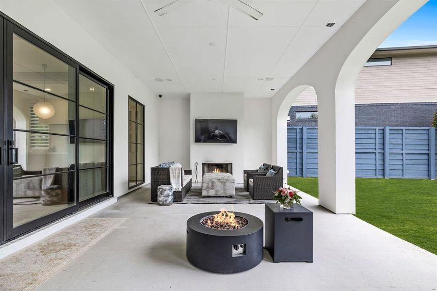 View of patio featuring an outdoor fire pit and a fireplace