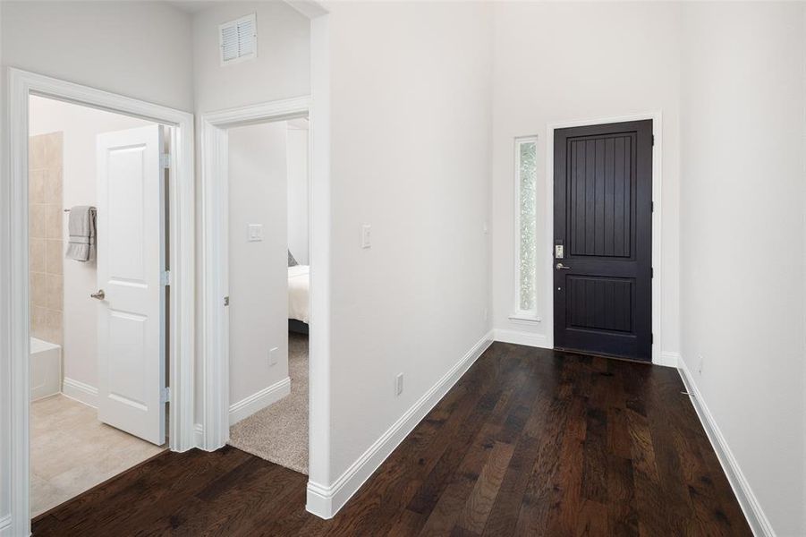 Entrance foyer with wood-type flooring