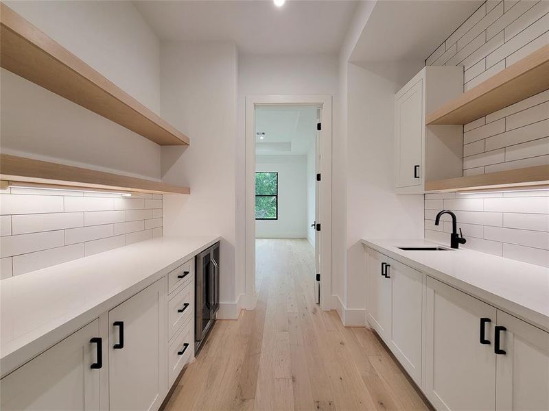 Entry to primary bedroom with coffee bar, beverage cooler & storage.