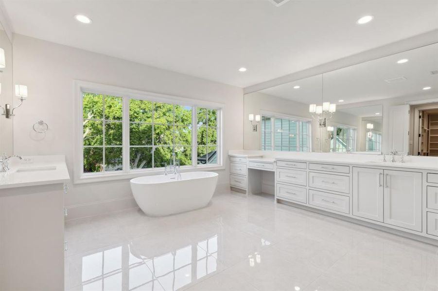 Bathroom featuring an inviting chandelier, tile patterned floors, plenty of natural light, and double vanity