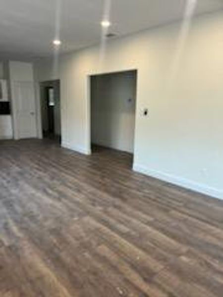 Unfurnished living room featuring dark hardwood / wood-style flooring