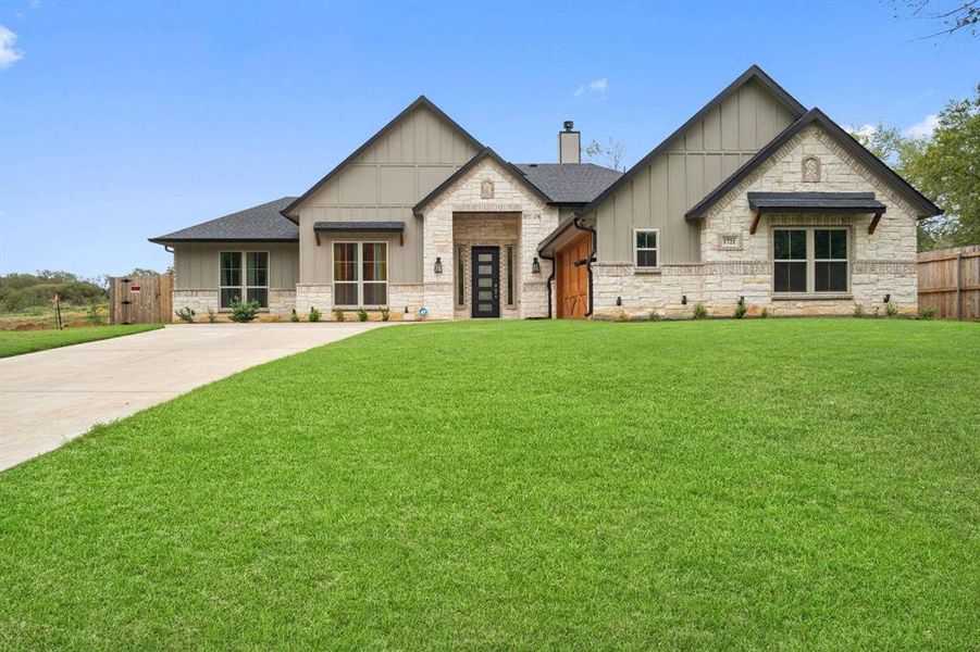 View of front of property with a front yard