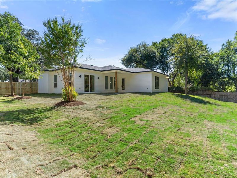 Rear view of house featuring a patio area and a yard