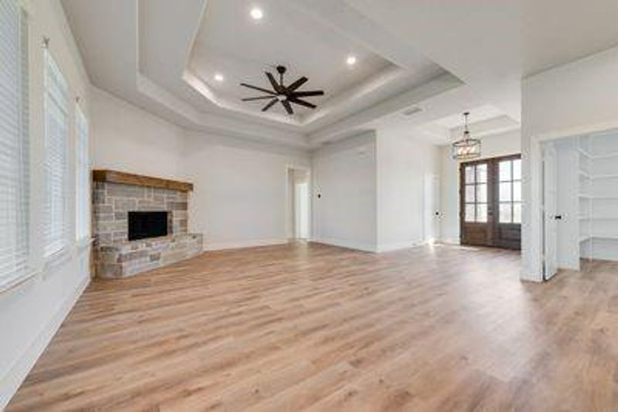 Unfurnished living room featuring french doors, light hardwood / wood-style floors, and ceiling fan