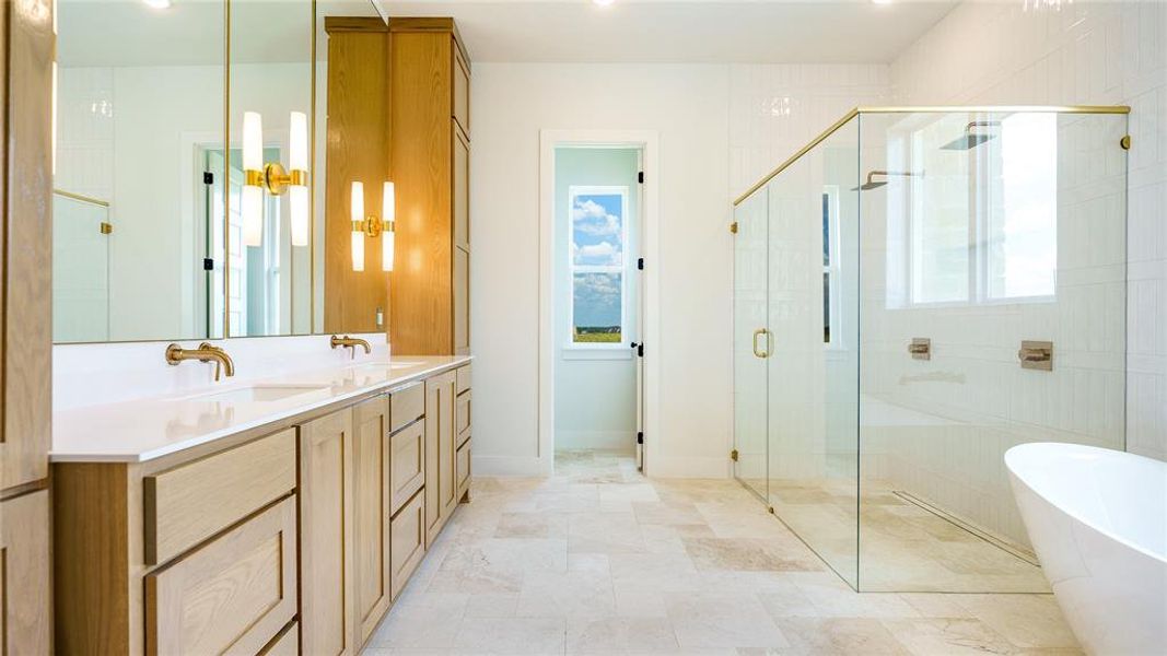 Bathroom featuring tile floors, dual sinks, separate shower and tub, and large vanity