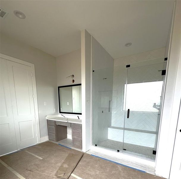 Makeup vanity and the oversized shower in the primary bath