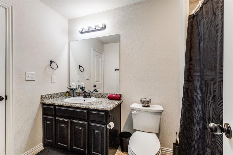 Bathroom featuring vanity and toilet