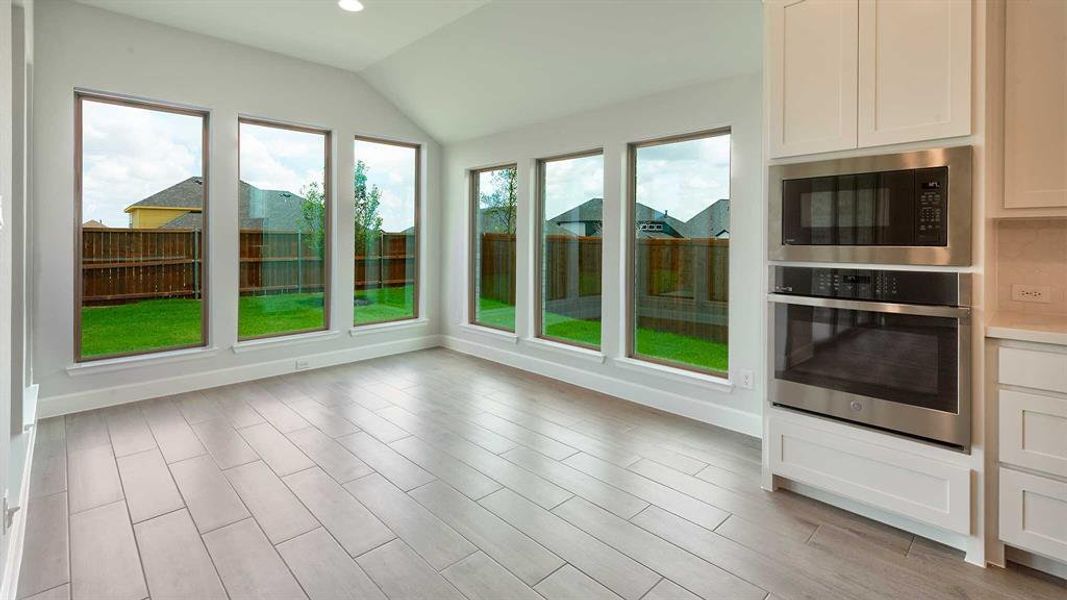 Unfurnished sunroom featuring lofted ceiling