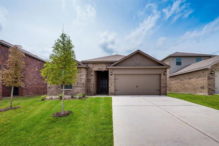 View of front facade with a garage and a front yard