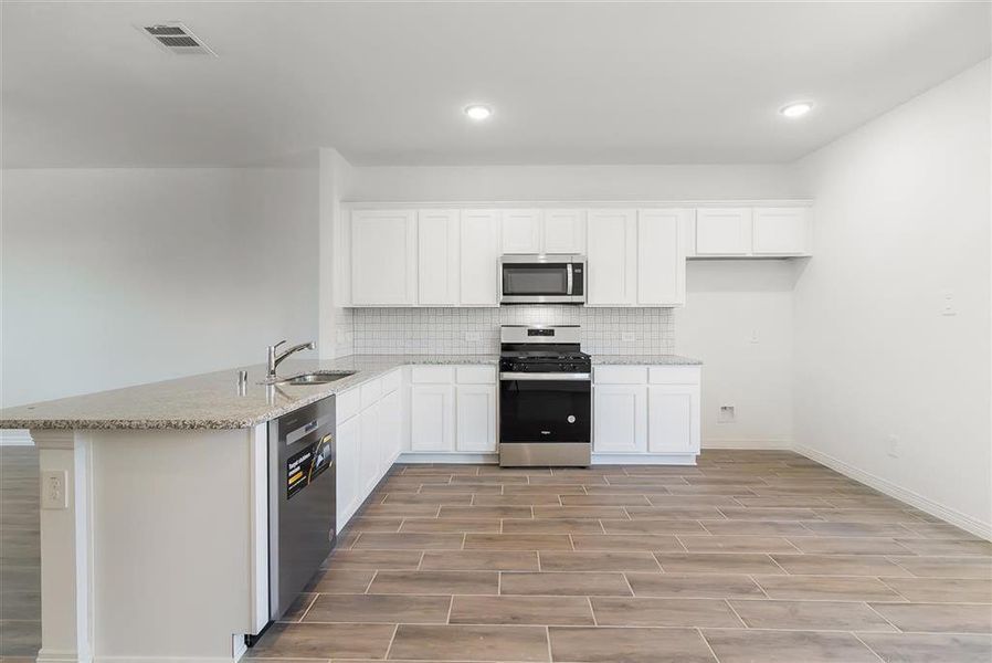 A large kitchen space that overlooks the XL backyard and covered back patio.