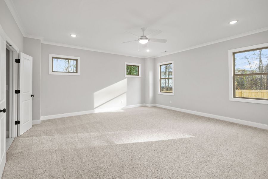 Primary bedroom includes a wall of windows for natural light