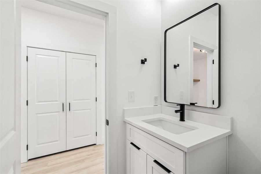 Bathroom featuring hardwood / wood-style floors and vanity