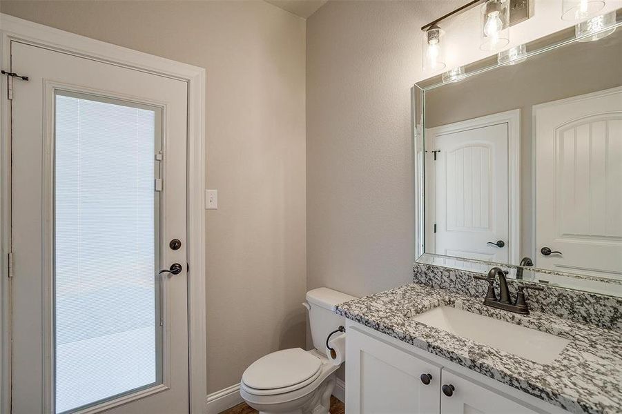 Half-bath with door to the back patio