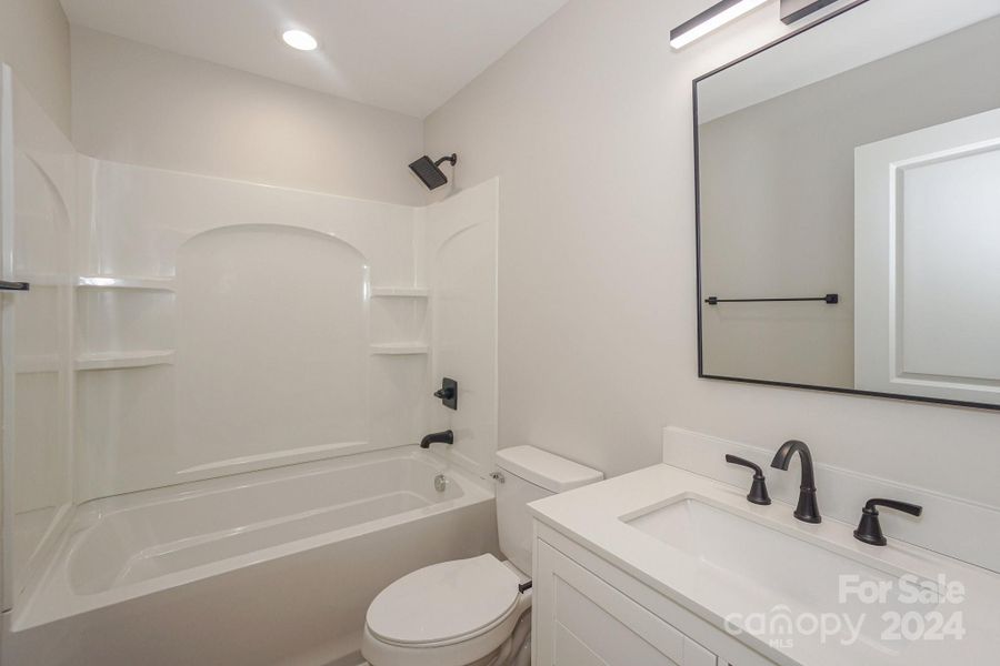 (Representative photo) At the end of the hall, you will find this full bathroom to accommodate bedrooms 2 and 3 or guests. It will have a tub/shower unit.