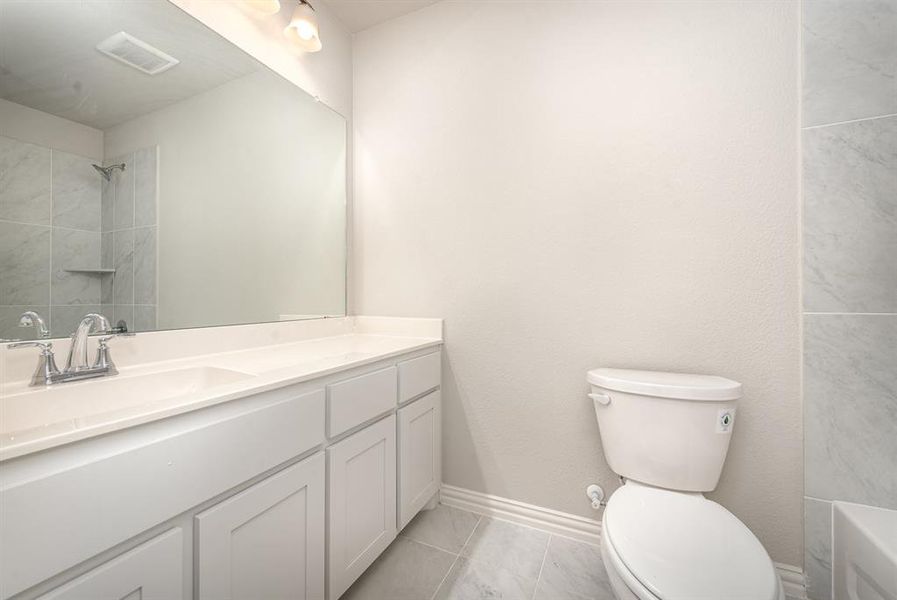 Bathroom with vanity, tile patterned flooring, and toilet
