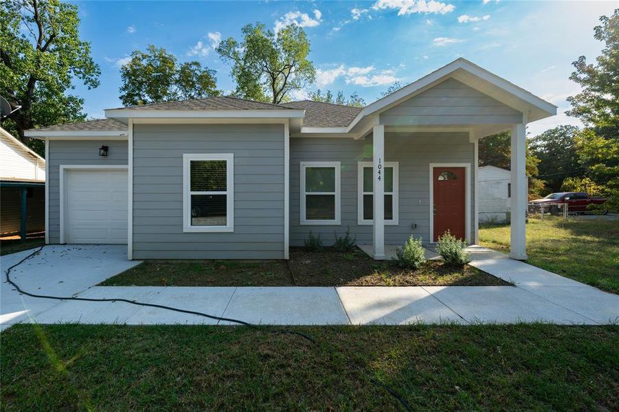 View of front of house featuring a garage and a front yard