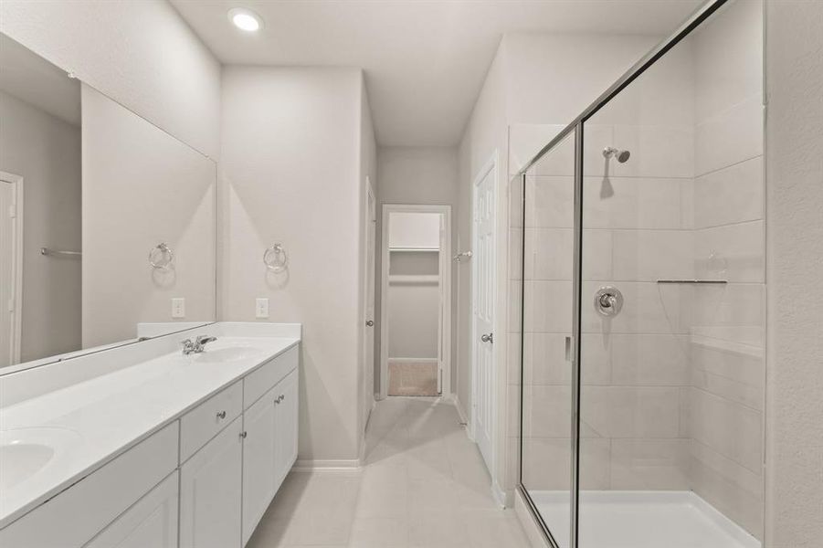 This additional view of your primary bathroom features tile flooring, fresh paint, and large walk-in shower.