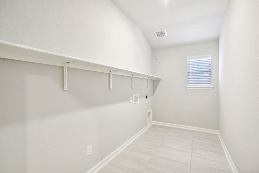 Laundry room in the Fitzhugh floorplan at a Meritage homes community.