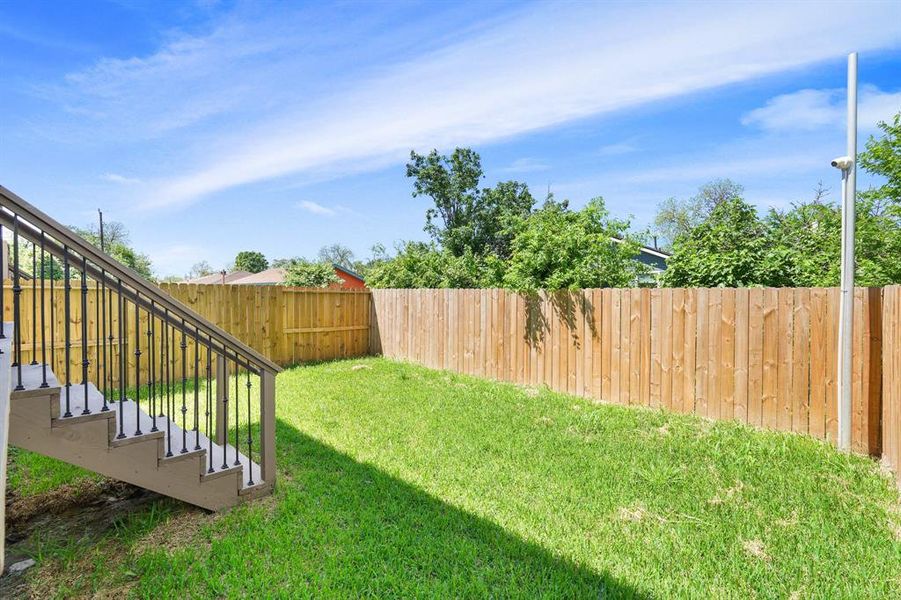 This backyard features solid board fencing providing more privacy.